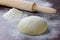 Dough with rolling pin and flour