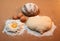 Dough in the shape of a heart, round bread, three eggs, and the yolk surrounded by flour