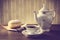 Doughnut with cup of tea on table in old-fashioned