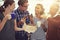 Doughnuts and coffee the perfect coffee break combo. Shot of a group of coworkers eating donuts while standing in an