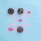 Doughnuts colorful playing Tick Tack Toe with pink kisses. Food aesthetic flat lay design idea. Playing love game
