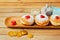 Doughnuts with jam on wooden plate with golden coins for Jewish Holiday Hanukkah