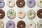 Doughnuts set. Top view of delicious assorted round glazed donuts with colorful sprinkles