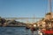 Douro river with traditional boats and Dom Luis iron bridge