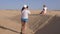 Douz, Tunisia - 10 June 2018: young woman making photo by mobile phone while tourist excursion in Sahara desert. Tourist