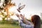 Dove flies into the hands of a woman during prayer as a symbol of hope