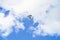 Dove flying in the sky against a background of white clouds