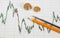 Dow Jones Business chart with paper clips, coins and pencil