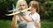 Down syndrome boy playing plane with mom