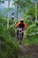 Downhill Bike Festival in Yogyakarta `Teras CAF`. A participant in the Mountain Bike Festival cycles down the hill fast and agil