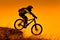 Downhill mountain bike rider at sunset