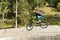 Downhill mountain biker jumping high and riding hard in Lenzerheide in the Swiss Alps