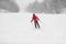 Downhill skiing Alpine ski during snowstorm. Woman athlete riding snowy slope in cold weather whiteout. winter snowsport