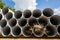 Downpipe warehouse. Steel pipes, parts for the construction of a roof drainage system in a warehouse. Stack of stainless