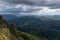 Downpour over mountains and gloomy clouds