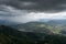 Downpour over mountains and gloomy clouds