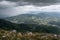 Downpour over mountains and gloomy clouds