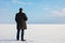 Downshifting way man standing on the shore of a frozen sea relax