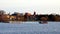 Downtown Bemidji is seen with people fishing in motor boat and on pier on Lake Bemidji.