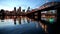 Downtown City Skyline of Portland Oregon along Willamette River with Hawthorne Bridge and Blue Hour Water Reflection Ripples