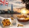 Downtown of London against fish and chips served on the table in England, United Kingdom