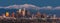 Downtown Los Angeles skyline with snow capped mountains behind at twilight