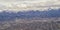 Downtown Salt Lake City Panoramic view of Wasatch Front Rocky Mountains from airplane in early spring winter with melting snow and