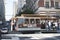 Downtown of San Francisco. Cable car in motion close up. Skyscrapers, cars, people walking