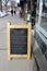Downtown sidewalks with large chalkboard signs advertising sales, Saratoga Springs, New York, 2018