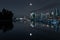 Downtown vancouver canada on a clear night with a full moon reflection