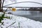 Downtown view on the city of Maastricht during an unusual snow fall in April. Snowflakes are still falling and covering a daffodil