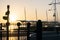 Downtown waterfront sunrise golden glow back-lights in silhouette barrier and railway signs