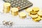 Downtrend stacks of golden coins, dices cubes