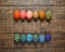 Dozen colorful painted Easter eggs on wooden background