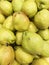 Dozen of pear in the basket in supermarket, pile of sweet pear in market, closed up