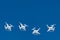 Dozens of drones swarm in the blue sky. Quadcopters drones with digital camera in the air over city. New technology in the aero