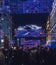 Dozens of people cross the street under Christmas lights in Gran Via, Madrid, Spain