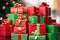 dozens of red and green gift boxes of varying sizes stacked high