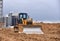 Dozer in action at construction site. Bulldozer for land clearing, demolition, pool excavation, utility trenching and foundation