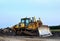 Dozer with bucket for pool excavation and utility trenching. Bulldozer during land clearing and foundation digging at construction