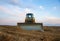 Dozer at open pit mining on sunseet background. Bulldozer for land clearing, grading, pool excavation, utility trenching and