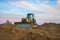 Dozer at open pit mining on sunseet background. Bulldozer for land clearing, grading, pool excavation, utility trenching and