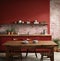 of a drab kitchen with red brick walls and a wooden table