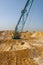 A dragline walking excavator produces sand