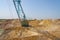 A dragline walking excavator produces sand