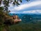 Dragon Crest mountain Krabi Thailand, a Young traveler sits on a rock that overhangs the abyss, with a beautiful