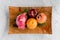 Dragon fruit or Pitaya,apples, pomegranates and oranges in a wooden dish