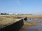 By drain outflow to shoreline with chemical plants in background