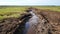 Drainage ditch in the peat extraction site. Drainage and destruction of peat bogs. Generative Ai