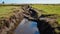 Drainage ditch in the peat extraction site. Drainage and destruction of peat bogs. Generative Ai